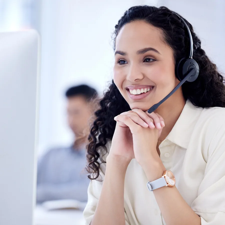 Helpdesk analyst on a headset at her desk
