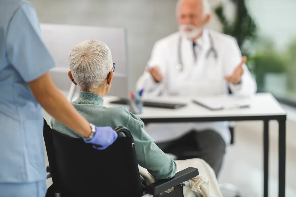 Carer accompanying a resident in a wheelchair to an appointment