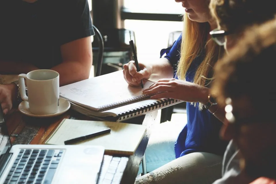 Managers working through paperwork together at a table