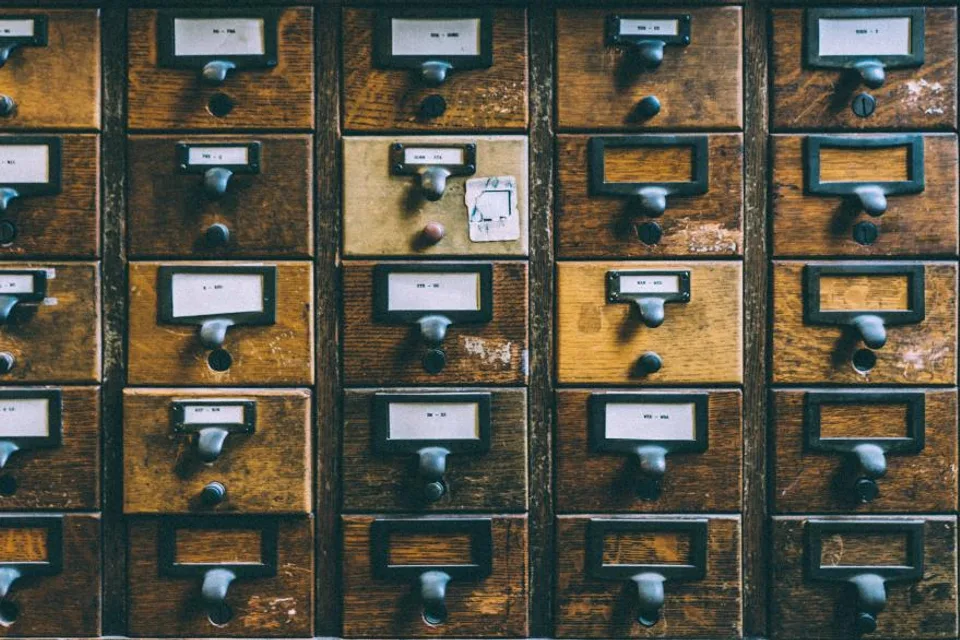 Wall of labelled drawers in a library card catalogue