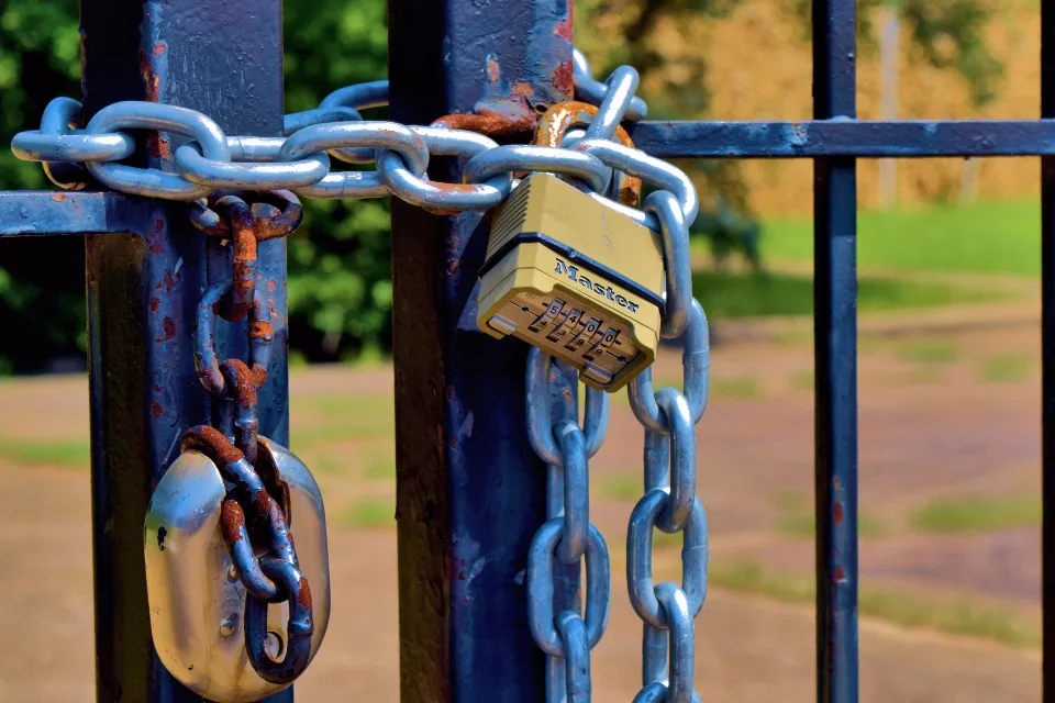 Metal gate secured with chains and padlocks