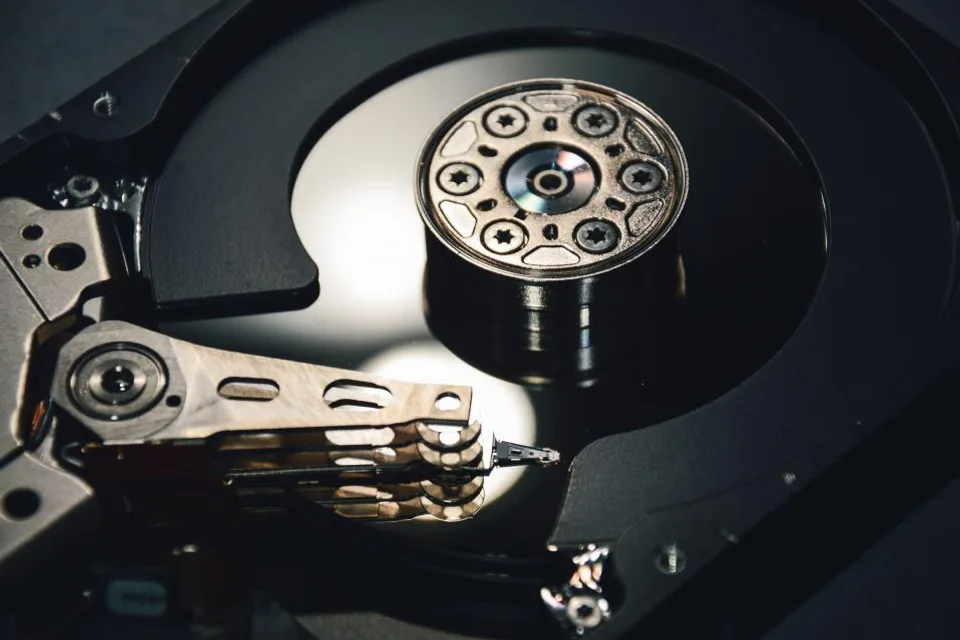 Inside of a hard drive showing the platter and read arm