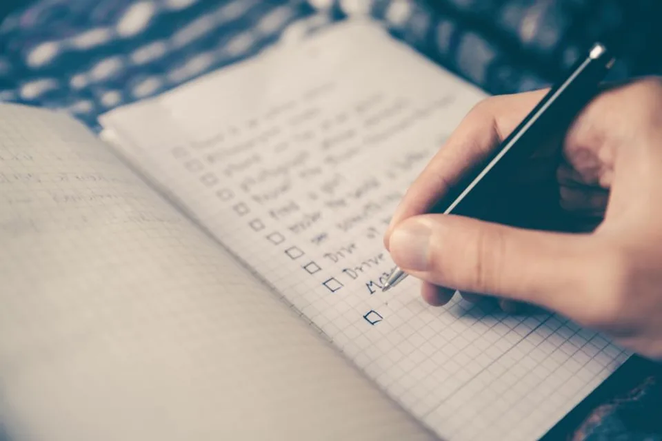 Working down a handwritten checklist, ticking items off